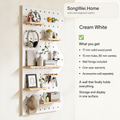 Cream white solid wood pegboard panel with shelves and pegs, shown with accessories