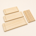 Three solid pine shelves in 10x20, 10x30 and 10x40 cm with six dowels on a white background