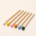 Six coloured wooden matchstick pegs 15 mm by 14.5 cm on a white background